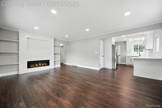 1418 W 13 Mile Rd, Royal Oak, MI 48073 - unfurnished living room with a large fireplace, dark wood-type flooring, crown molding, and recessed lighting