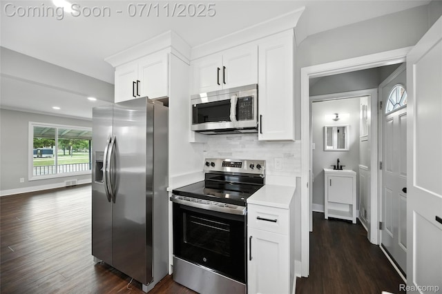 1418 W 13 Mile Rd, Royal Oak, MI 48073 - kitchen featuring stainless steel appliances, tasteful backsplash, dark wood-type flooring, white cabinets, and recessed lighting