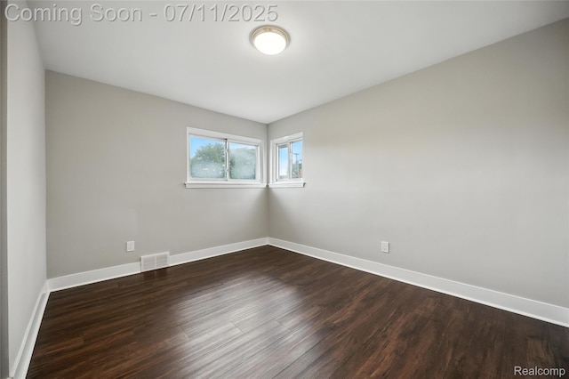 1418 W 13 Mile Rd, Royal Oak, MI 48073 - empty room featuring dark wood-style floors and baseboards