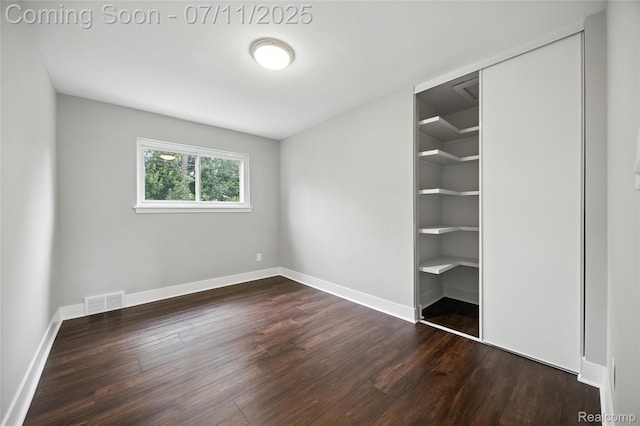 1418 W 13 Mile Rd, Royal Oak, MI 48073 - unfurnished bedroom with dark wood-type flooring and a closet