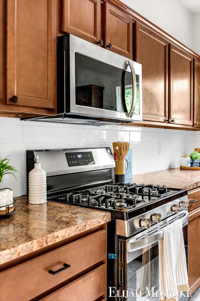 243 Page St NE, Grand Rapids, MI 49505 - kitchen with stainless steel appliances and decorative backsplash