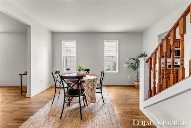 243 Page St NE, Grand Rapids, MI 49505 - dining room with stairs and light wood-style flooring