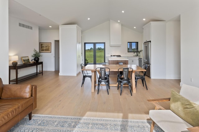 6581 Timpson Ave SE, Alto, MI 49302 - dining space with high vaulted ceiling, light wood-style floors, and recessed lighting
