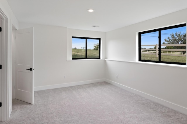 6581 Timpson Ave SE, Alto, MI 49302 - empty room featuring healthy amount of natural light, carpet floors, and recessed lighting