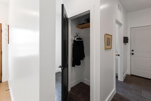 6581 Timpson Ave SE, Alto, MI 49302 - hall with dark tile patterned flooring and baseboards