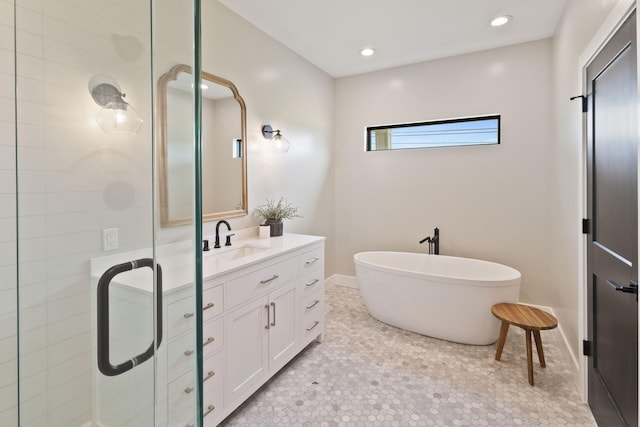 6581 Timpson Ave SE, Alto, MI 49302 - bathroom featuring vanity, a shower stall, a freestanding bath, and recessed lighting