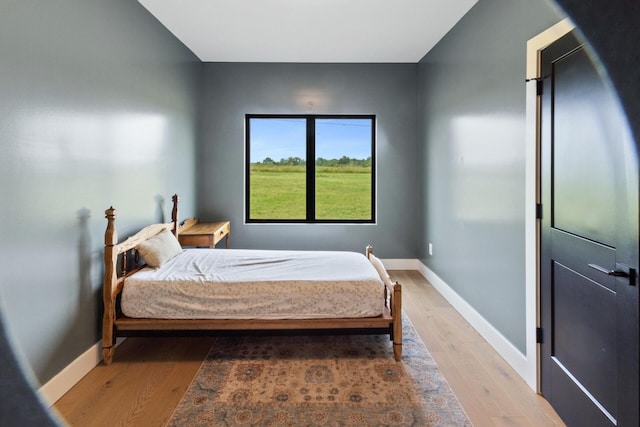 6581 Timpson Ave SE, Alto, MI 49302 - bedroom featuring wood finished floors and baseboards