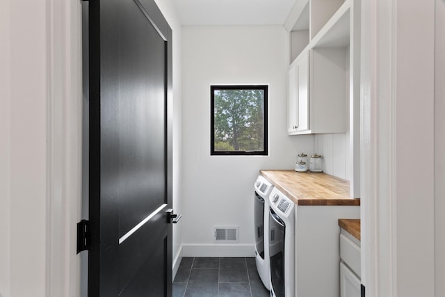 6581 Timpson Ave SE, Alto, MI 49302 - washroom with washer and dryer, cabinet space, and dark tile patterned flooring