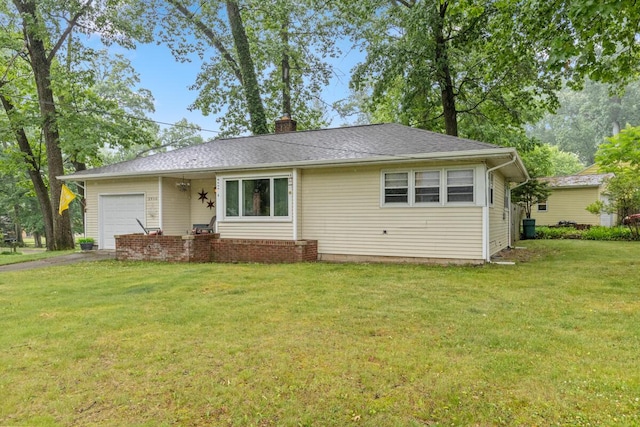 2925 Dawes Ave SE, Grand Rapids, MI 49508 - view of front facade with a garage, a front yard, asphalt driveway, and a chimney