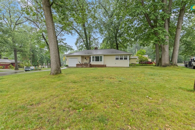 2925 Dawes Ave SE, Grand Rapids, MI 49508 - view of front of property featuring a garage, a front yard, and a chimney