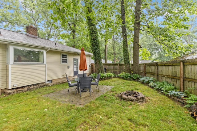 2925 Dawes Ave SE, Grand Rapids, MI 49508 - fenced backyard featuring a fire pit and a patio area