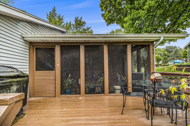 7289 Eagle Ter, Michigan, MI 49071 - wooden deck with a sunroom and outdoor dining area