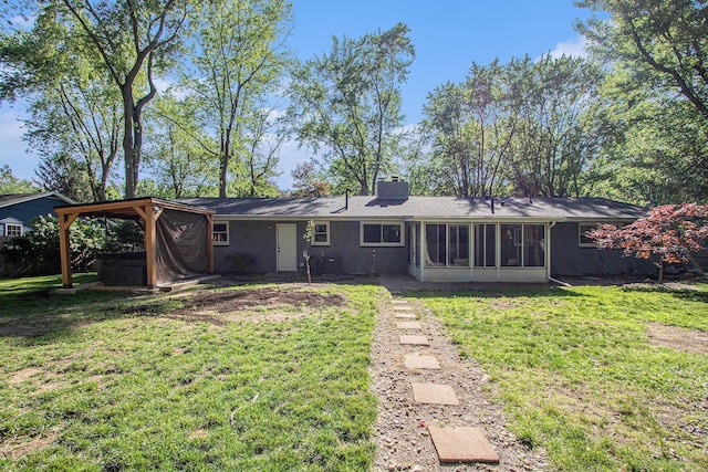 3365 Circle Dr, Saint Joseph, MI 49085 - rear view of house with a chimney, a sunroom, a lawn, and a jacuzzi