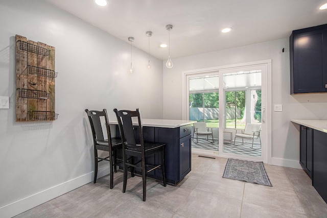 3365 Circle Dr, Saint Joseph, MI 49085 - kitchen with a breakfast bar, a peninsula, light countertops, dark cabinetry, and recessed lighting