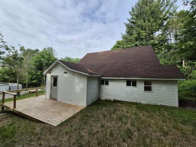 17324 11 Mile Rd, Leroy, MI 49655 - rear view of house featuring a deck, a shingled roof, and an outdoor structure