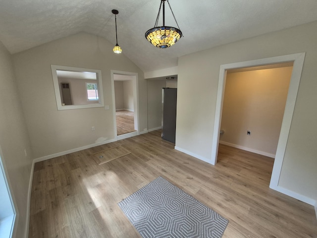 17324 11 Mile Rd, Leroy, MI 49655 - unfurnished dining area featuring lofted ceiling and light wood-type flooring