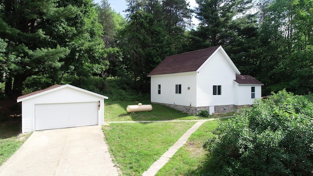 17324 11 Mile Rd, Leroy, MI 49655 - view of side of home with a detached garage, a lawn, an outdoor structure, and a shingled roof