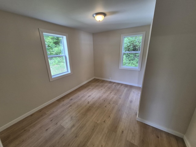 17324 11 Mile Rd, Leroy, MI 49655 - empty room with healthy amount of natural light and wood finished floors
