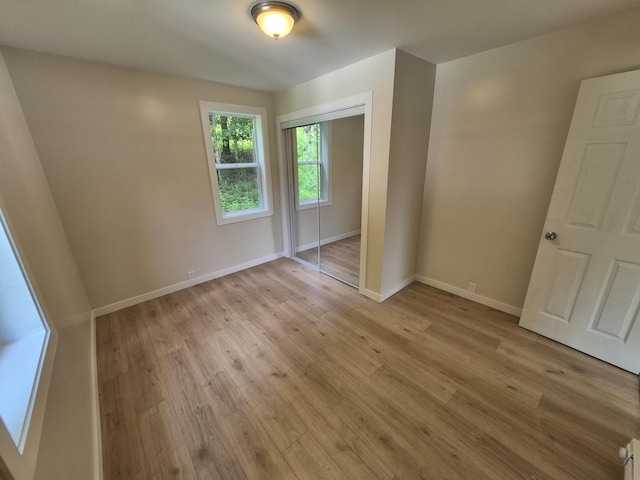 17324 11 Mile Rd, Leroy, MI 49655 - unfurnished bedroom featuring light wood-type flooring and a closet