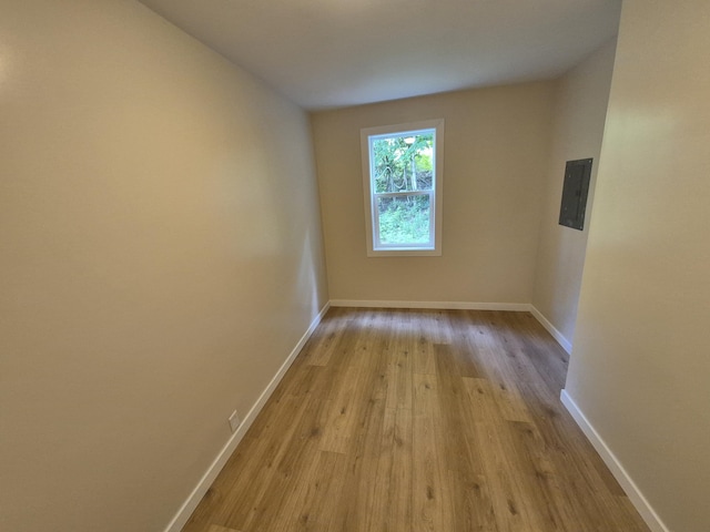 17324 11 Mile Rd, Leroy, MI 49655 - spare room with electric panel and wood finished floors