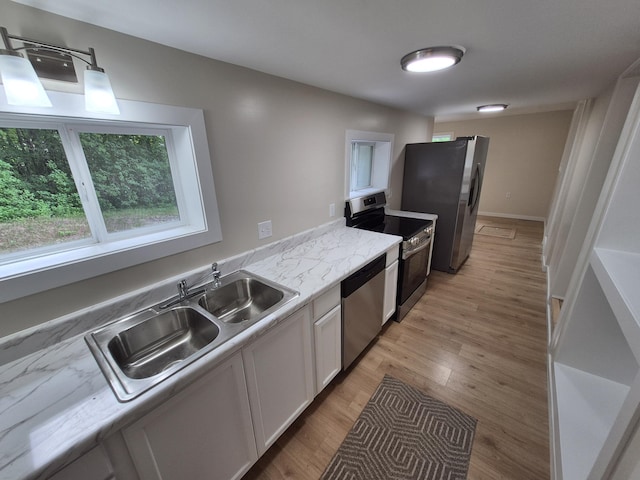 17324 11 Mile Rd, Leroy, MI 49655 - kitchen featuring stainless steel appliances, white cabinetry, and light wood-style floors