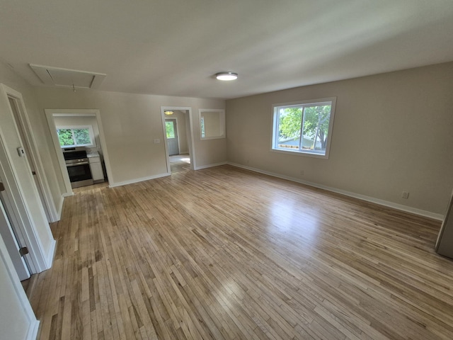 17324 11 Mile Rd, Leroy, MI 49655 - unfurnished room featuring attic access, light wood-type flooring, and plenty of natural light
