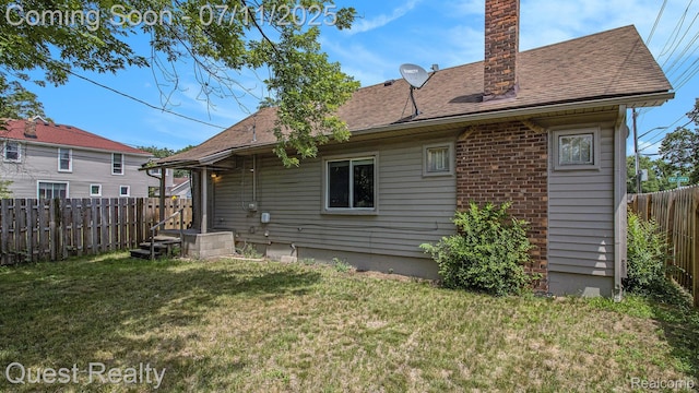 21005 Westview Ave, Ferndale, MI 48220 - rear view of property featuring a fenced backyard, a chimney, and roof with shingles