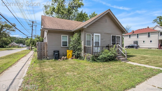 21005 Westview Ave, Ferndale, MI 48220 - view of front of property featuring a shingled roof, a front lawn, and a deck