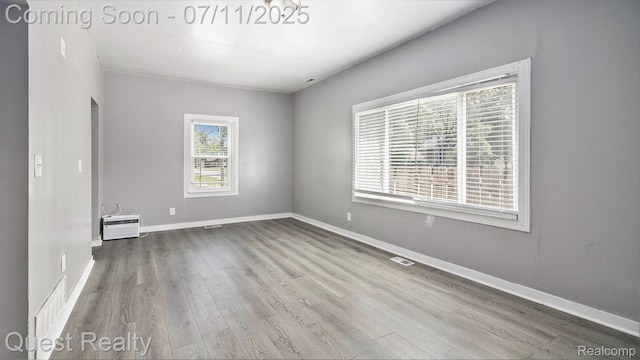 21005 Westview Ave, Ferndale, MI 48220 - empty room with wood finished floors and an AC wall unit