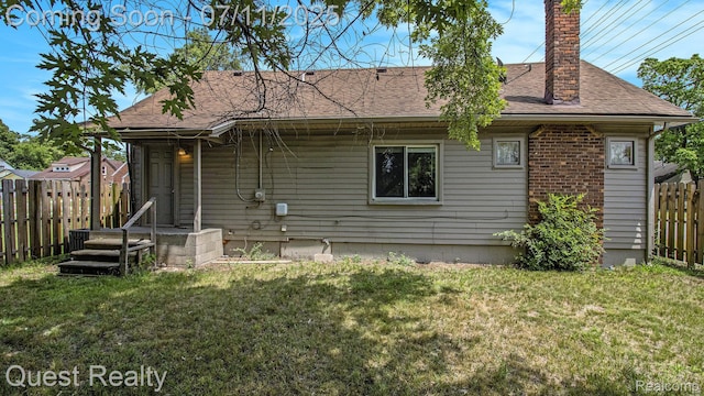 21005 Westview Ave, Ferndale, MI 48220 - back of property with a fenced backyard, a chimney, and a shingled roof