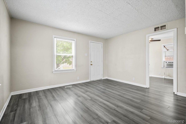 1771 E George Ave, Hazel Park, MI 48030 - spare room with dark wood finished floors, a textured ceiling, and cooling unit