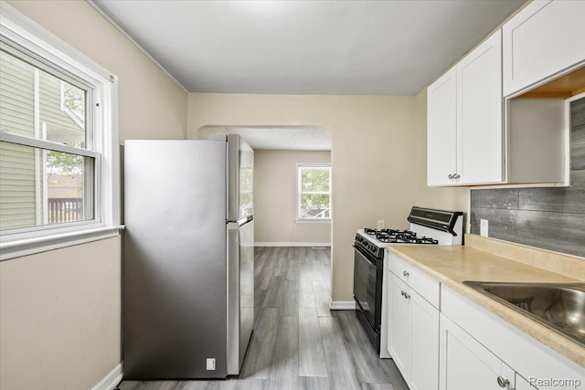 1771 E George Ave, Hazel Park, MI 48030 - kitchen with freestanding refrigerator, gas stove, and white cabinets