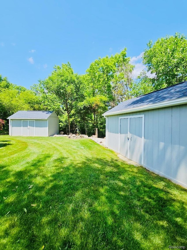 4383 Eagle Ln, Burton, MI 48519 - view of green lawn featuring a storage unit