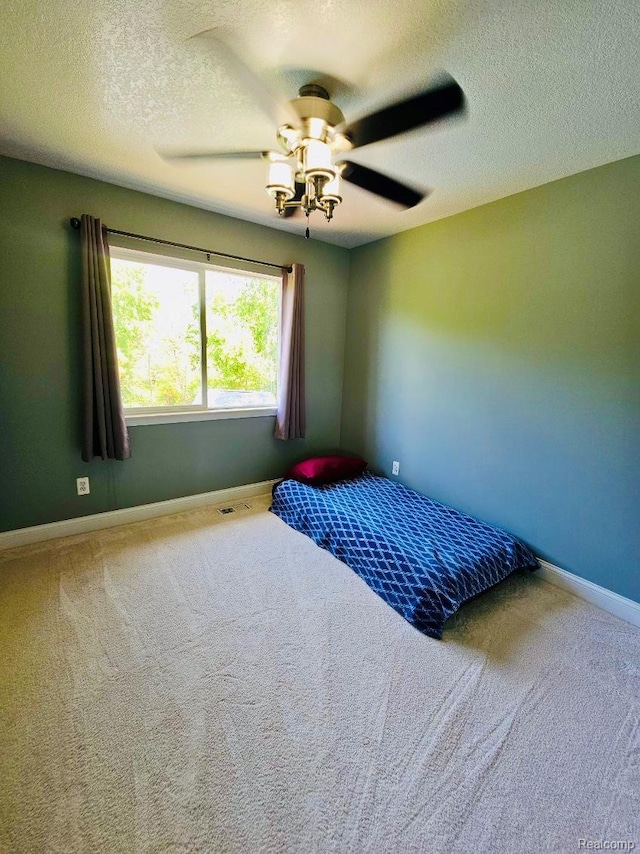 4383 Eagle Ln, Burton, MI 48519 - carpeted bedroom featuring a textured ceiling and a ceiling fan