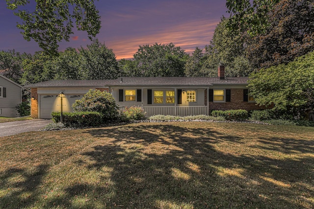 4650 Rollridge Ave, Kalamazoo, MI 49004 - ranch-style home featuring a chimney, brick siding, a garage, driveway, and a front yard