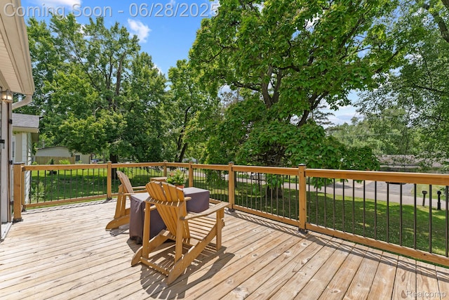 4860 Lindholm Dr, White Lake, MI 48383 - deck featuring view of wooded area and a lawn