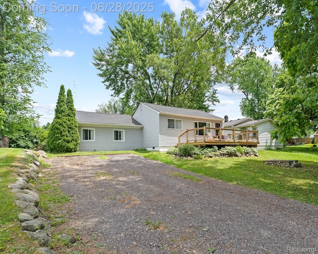 4860 Lindholm Dr, White Lake, MI 48383 - view of front of property featuring a wooden deck, dirt driveway, a front lawn, and crawl space