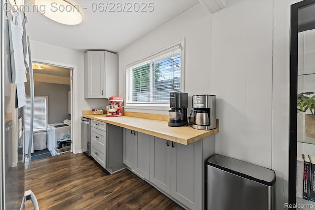 4860 Lindholm Dr, White Lake, MI 48383 - kitchen featuring gray cabinets, butcher block counters, dark wood-style flooring, stainless steel appliances, and built in desk