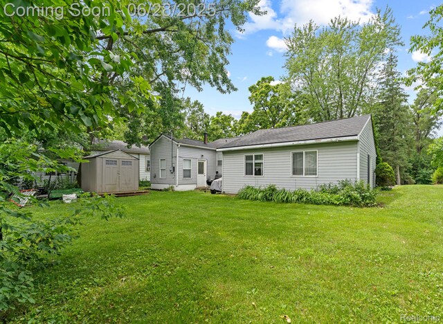 4860 Lindholm Dr, White Lake, MI 48383 - back of house with a storage unit and a lawn