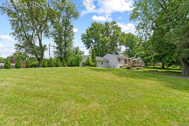 4860 Lindholm Dr, White Lake, MI 48383 - view of grassy yard featuring a deck