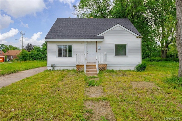 19966 Lindsay St, Detroit, MI 48235 - view of front of house with a shingled roof and a front yard