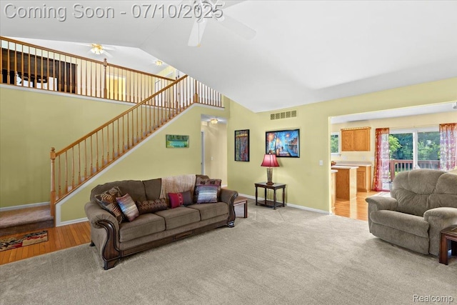 12366 Orchard Wood Dr, Fenton, MI 48430 - carpeted living area featuring ceiling fan, vaulted ceiling, and stairs
