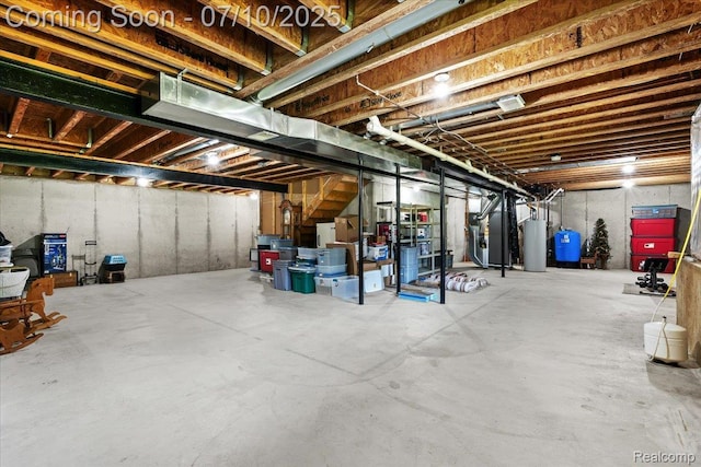 12366 Orchard Wood Dr, Fenton, MI 48430 - unfinished below grade area with heating unit, water heater, and a water pressure tank