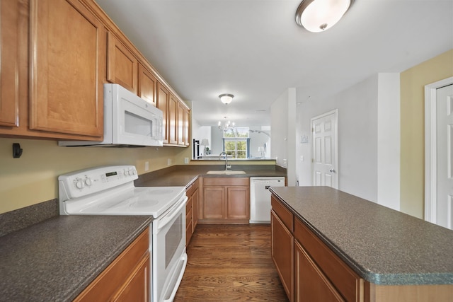662 Village Ln, Milford, MI 48381 - kitchen featuring white appliances, dark countertops, dark wood finished floors, and a chandelier