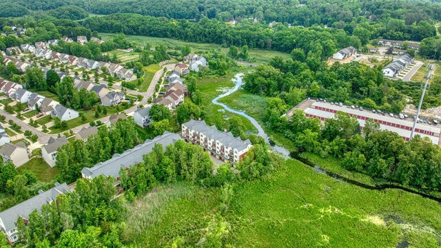 662 Village Ln, Milford, MI 48381 - aerial perspective of suburban area featuring a tree filled landscape