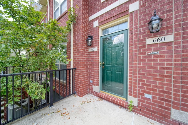 662 Village Ln, Milford, MI 48381 - doorway to property featuring brick siding