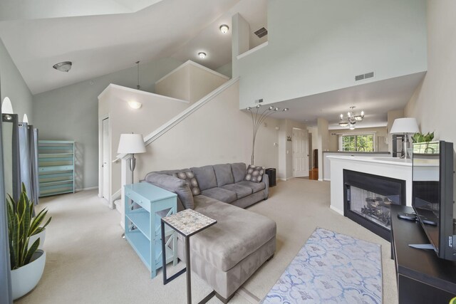 662 Village Ln, Milford, MI 48381 - carpeted living room with a chandelier and high vaulted ceiling