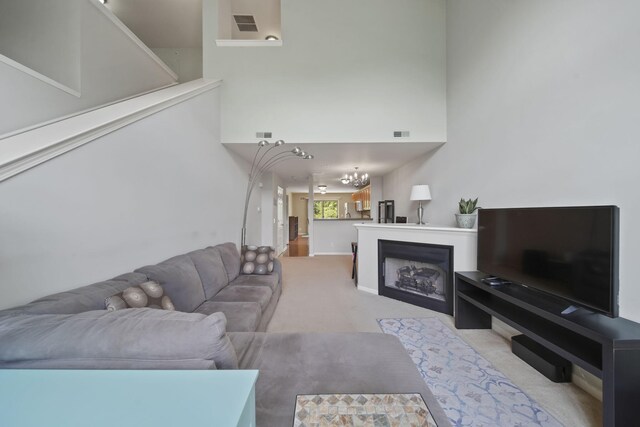 662 Village Ln, Milford, MI 48381 - living room with a chandelier, light colored carpet, and a towering ceiling