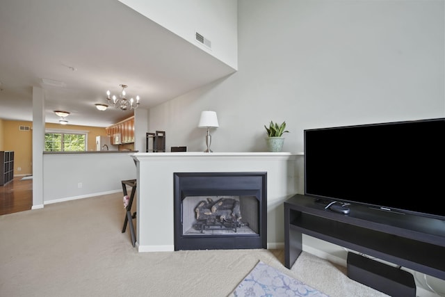 662 Village Ln, Milford, MI 48381 - carpeted living room featuring a chandelier and baseboards