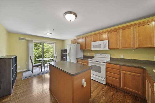 662 Village Ln, Milford, MI 48381 - kitchen with white appliances, dark countertops, a kitchen island, dark wood-style floors, and brown cabinets